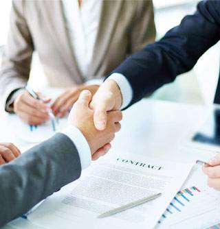 Business professionals shaking hands on a contract